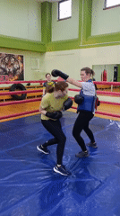 Women's boxing training session recorded at indoor gym facility