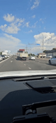 Highway traffic rolling through Krasnodar on a clear afternoon