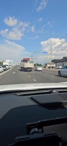 Highway traffic rolling through Krasnodar on a clear afternoon