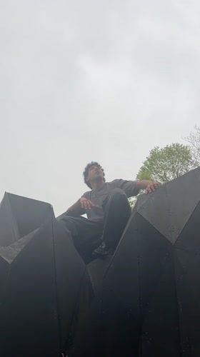 Young man explores Strasbourg climbing structures, visiting urban spots