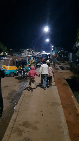 Nighttime street scenes document traffic, commerce in Bukuru Nigeria
