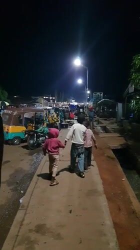 Nighttime street scenes document traffic, commerce in Bukuru Nigeria