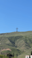 Metal cross monument filmed on hill in Rustavi, Georgia