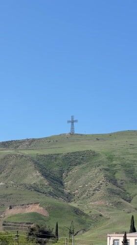 Metal cross monument filmed on hill in Rustavi, Georgia
