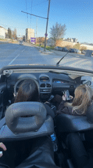 Two women cruise in white convertible through Varna