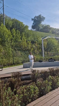 Riverfront activities captured in Perm including street saxophone performance
