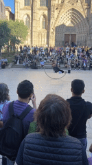 Street performer draws crowd with hoop acrobatics outside Barcelona cathedral
