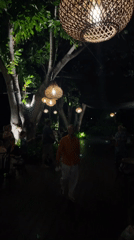 Bali resort grounds after dark, pools and gardens glowing