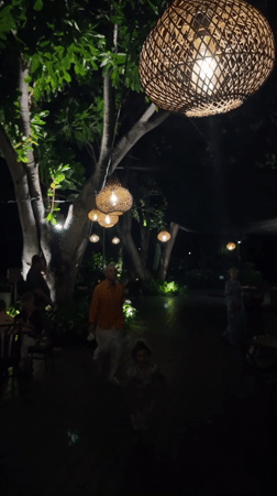 Bali resort grounds after dark, pools and gardens glowing