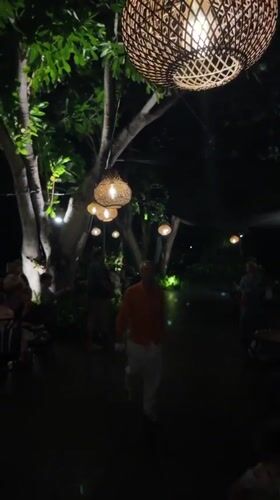 Bali resort grounds after dark, pools and gardens glowing