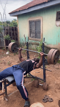 Men exercise with homemade gym equipment in Akwanga yards