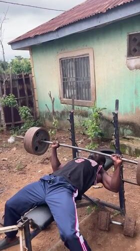 Men exercise with homemade gym equipment in Akwanga yards