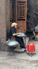 Street musician performs handpan at dawn in Da Lat