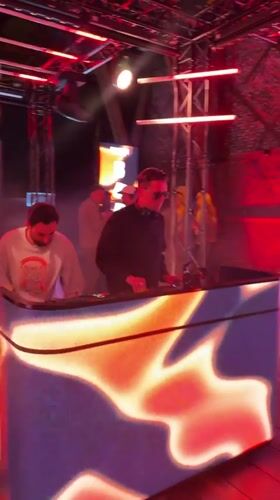 Evening party with DJ and red lighting in Oslo