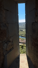 Tourist visits medieval castle overlooking Bosa, Sardinia