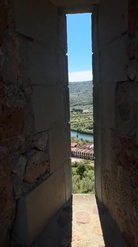 Tourist visits medieval castle overlooking Bosa, Sardinia