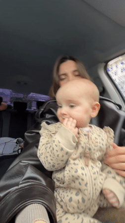 Mother and baby share quiet moment in parked Moscow car