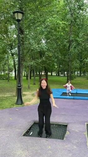 Jumping on an outdoor trampoline in a Moscow park