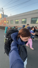 Departing Penza station at dusk, backpacks in tow