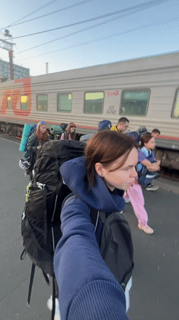 Departing Penza station at dusk, backpacks in tow