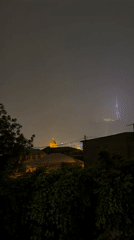 Nighttime cityscape views captured in Tbilisi showing golden-domed building