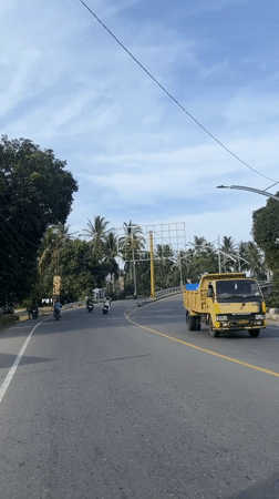 Road trip across a truss bridge in coastal Indonesia