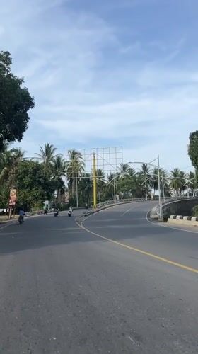 Road trip across a truss bridge in coastal Indonesia