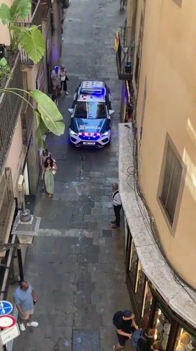 Police arrest on a cobblestone street in Barcelona