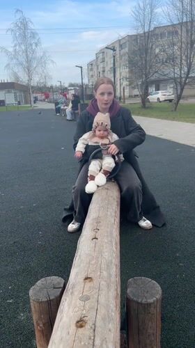 Mother and baby enjoy playground time in Pokrov, Russia