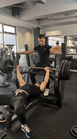 Men workout with spotter at Tsarevo gym