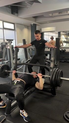 Men workout with spotter at Tsarevo gym