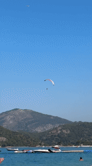 Paragliders, boats, and beach life on a Fethiye summer morning