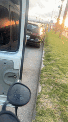 Person handles sunglasses in vehicle on Martil streets