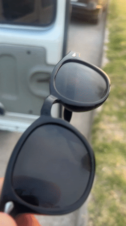 Person handles sunglasses in vehicle on Martil streets