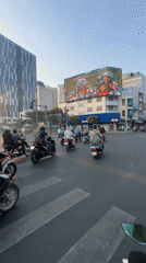 Busy motorbike traffic observed at Thủ Đức intersection during evening hours