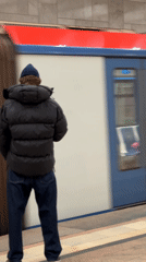 Commuter watches train pass at Khimki subway station