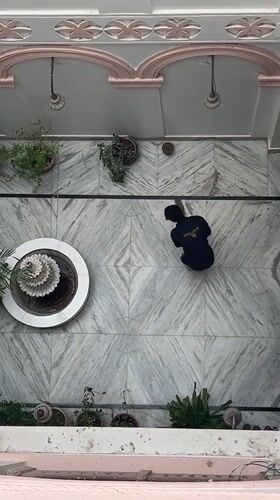 Sweeping a marble courtyard in Pushkar, India