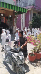 Community gathers in white attire for religious occasion in Sungelebak
