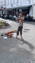 Street performer with fabric pole entertains on Saarbrücken cobblestones