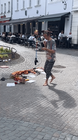Street performer with fabric pole entertains on Saarbrücken cobblestones