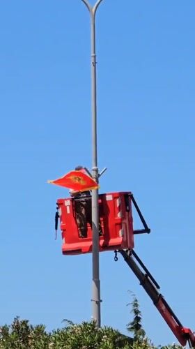 Worker installs Montenegro flag on street pole in Bar