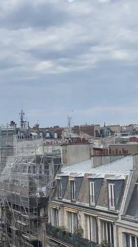 Helicopter and drone share the skies above Paris rooftops