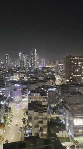 Evening aerial views document Bat Yam cityscape and coastline