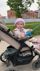 Child plays with bubbles in stroller in Shushary