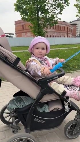 Child plays with bubbles in stroller in Shushary