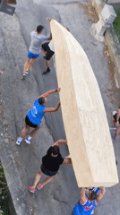 Wooden boat carried through Passignano sul Trasimeno streets