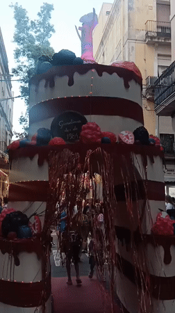 Giant cake display anchors a festive Barcelona street scene