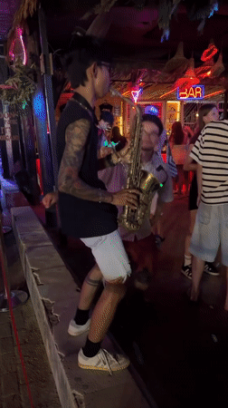 Live sax and neon nights at a coastal Indonesian bar