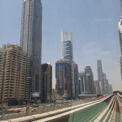 Metro rides through modern cityscape with food market stops
