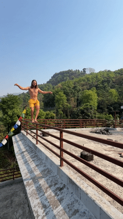 Man performs handstand on railing in Pokhara, Nepal